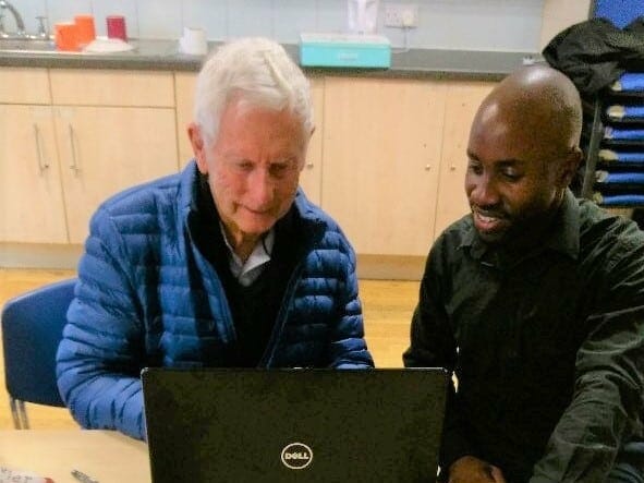 Jim and Sol from Deafblind UK, looking at a computer