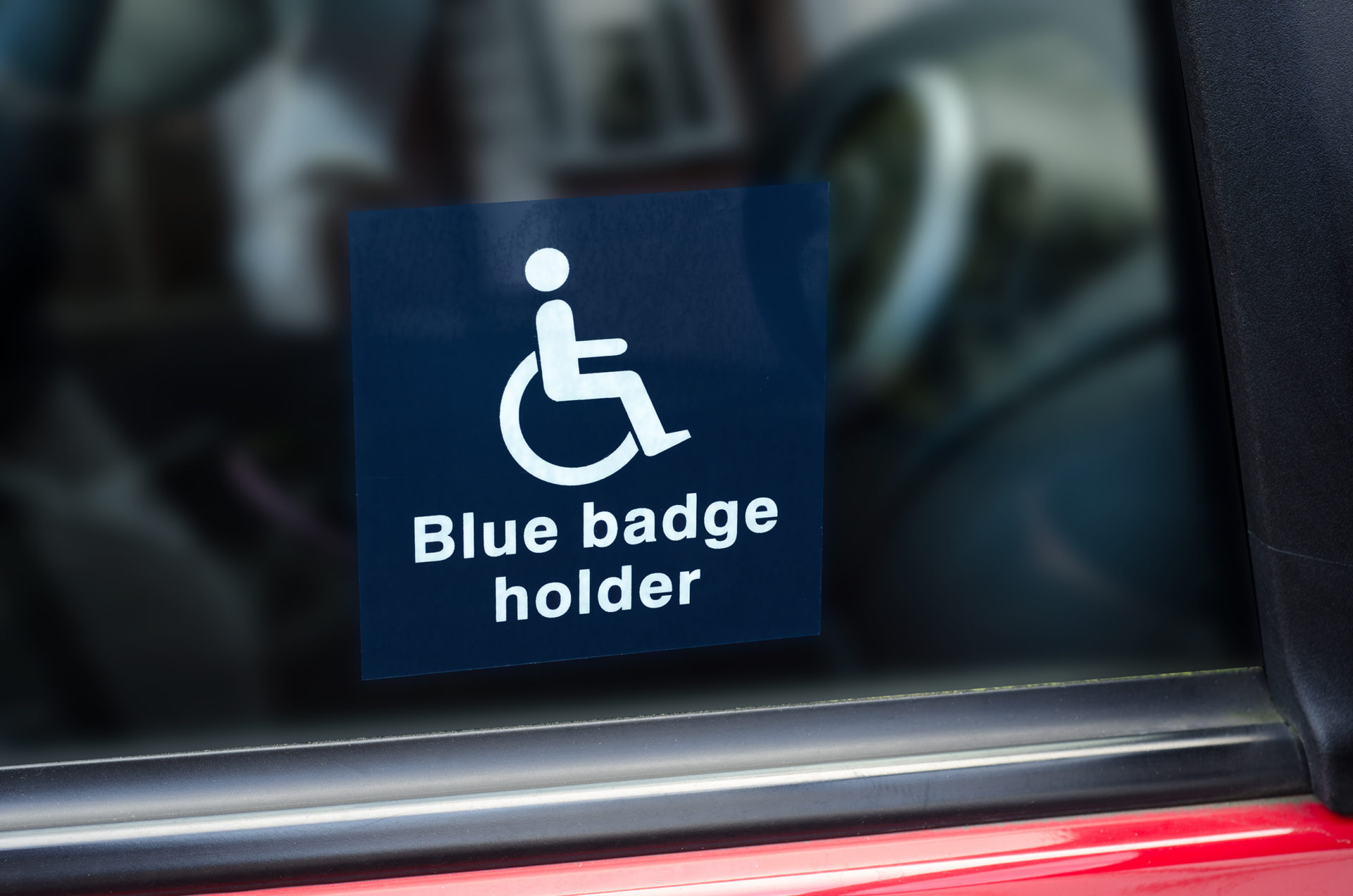 A Blue Badge disabled parking permit in a display wallet.