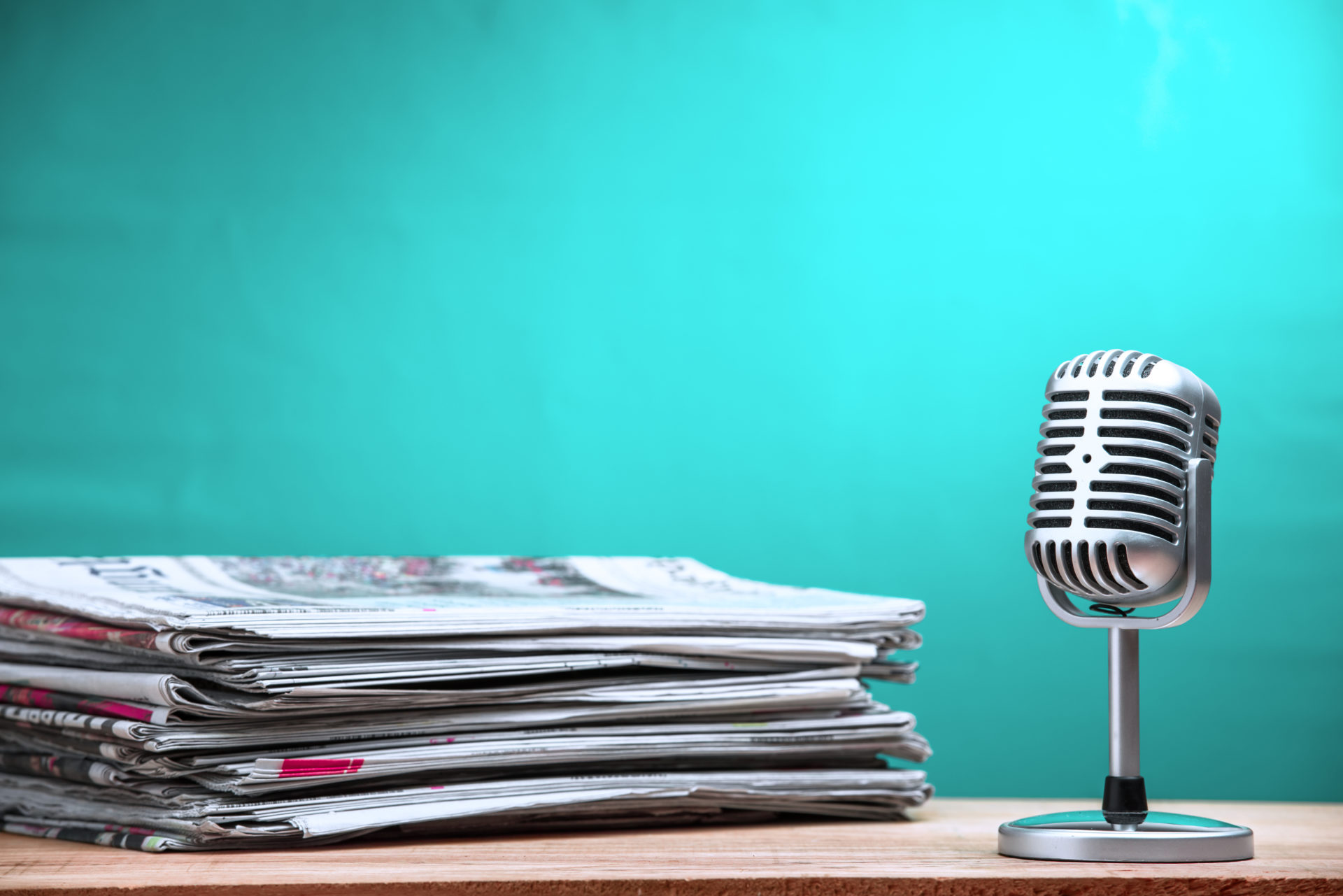 a pile of newspapers next to a microphone