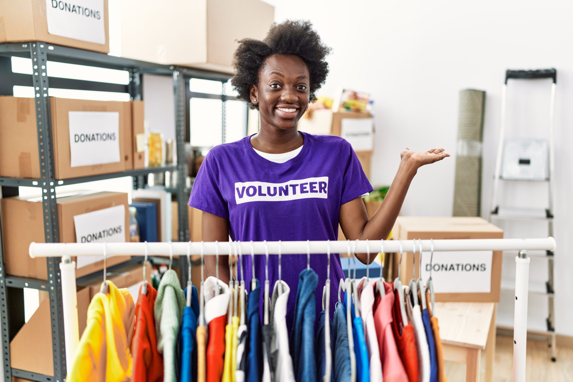 African,Young,Woman,Wearing,Volunteer,T,Shirt,At,Donations,Stand