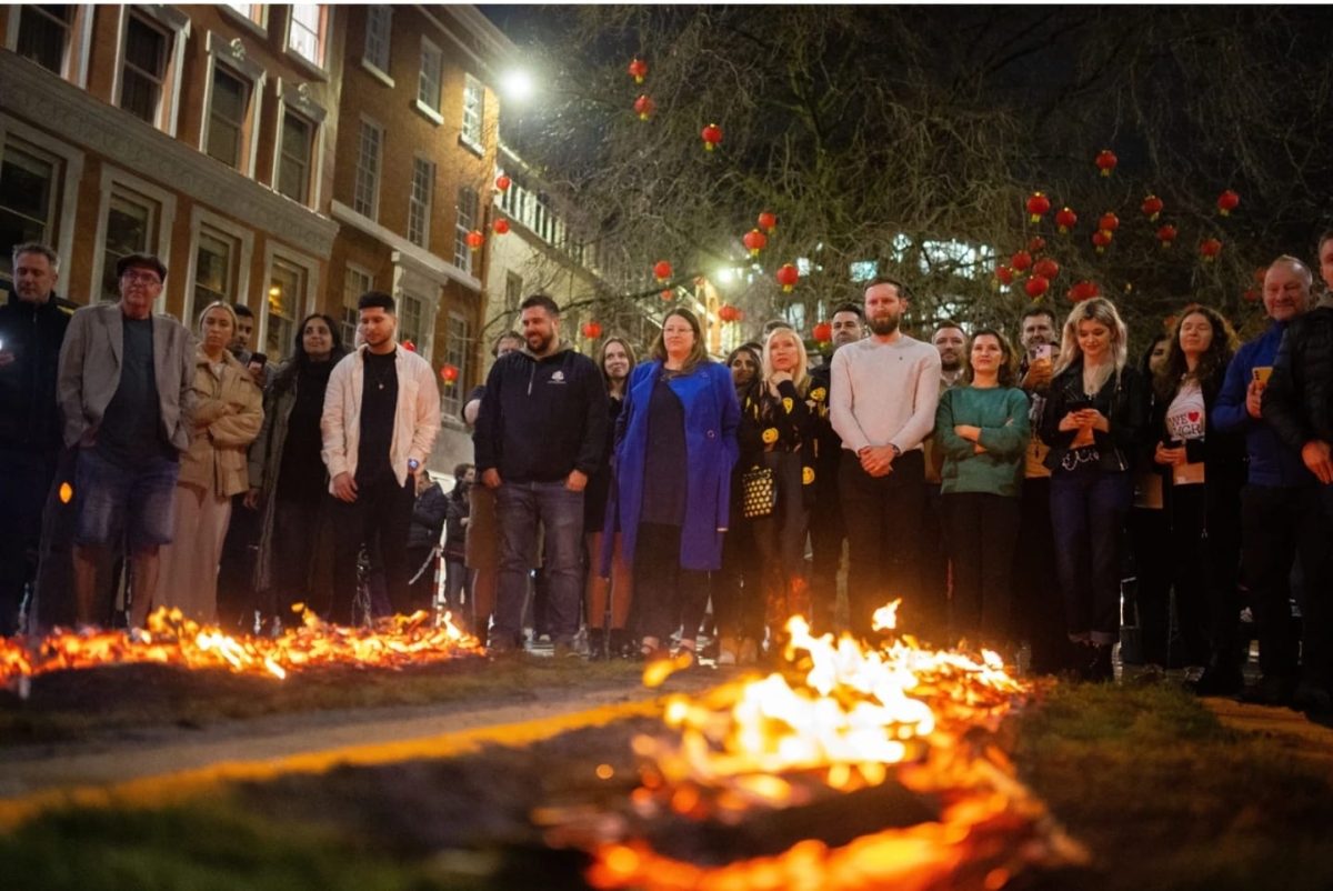 Participants gather around the firewalk lanes minutes before walking across