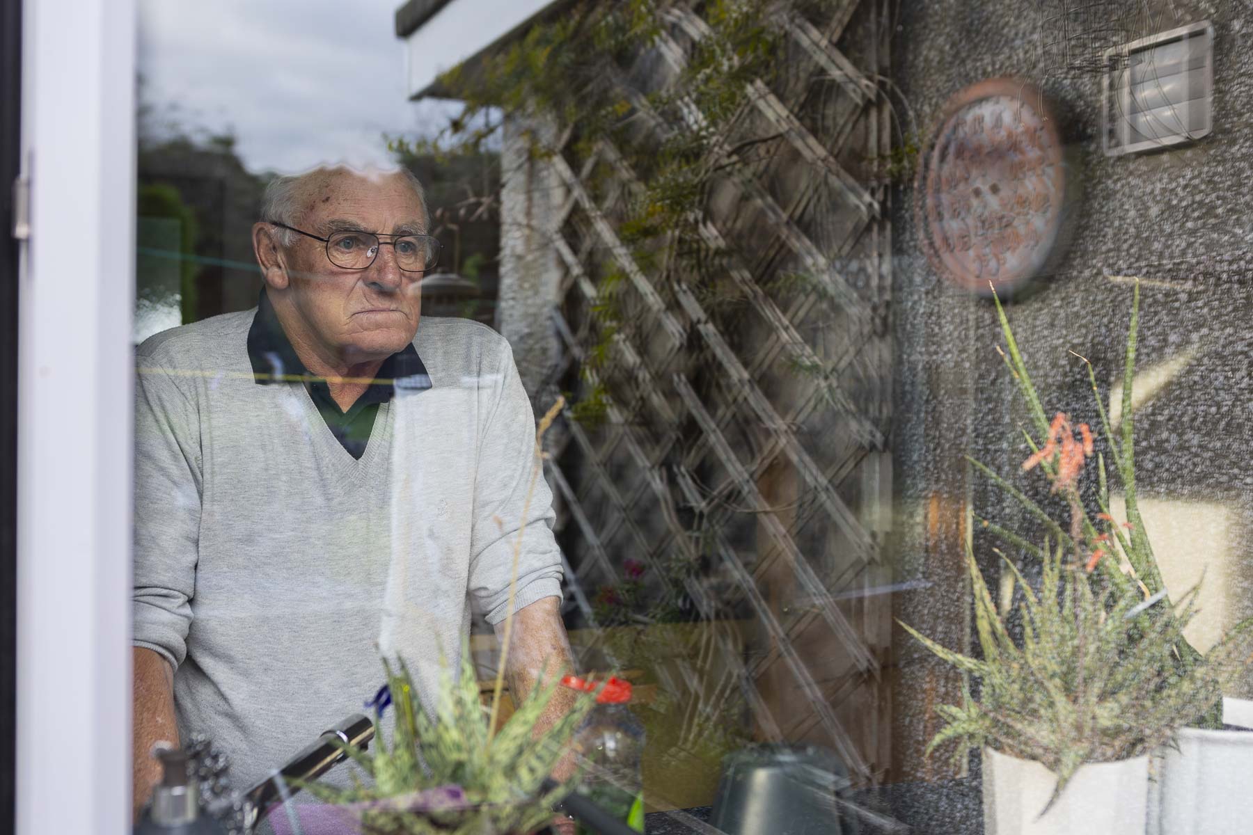 Stuart looks out through his kitchen window