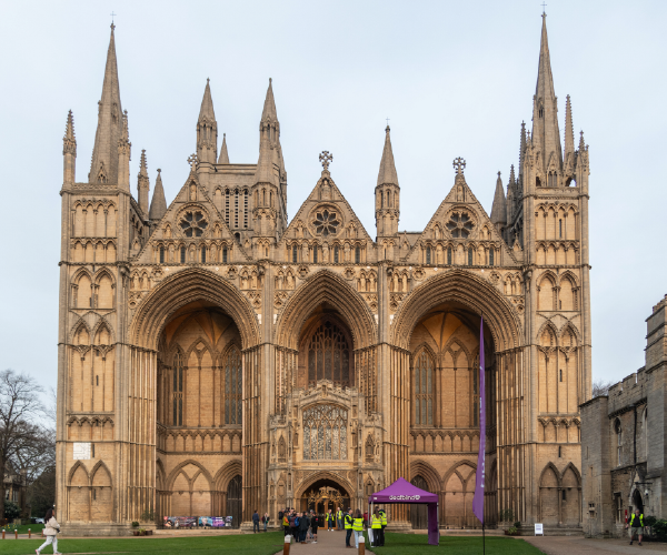 An image of the ornate gothic facade of Peterborough Cathedral.