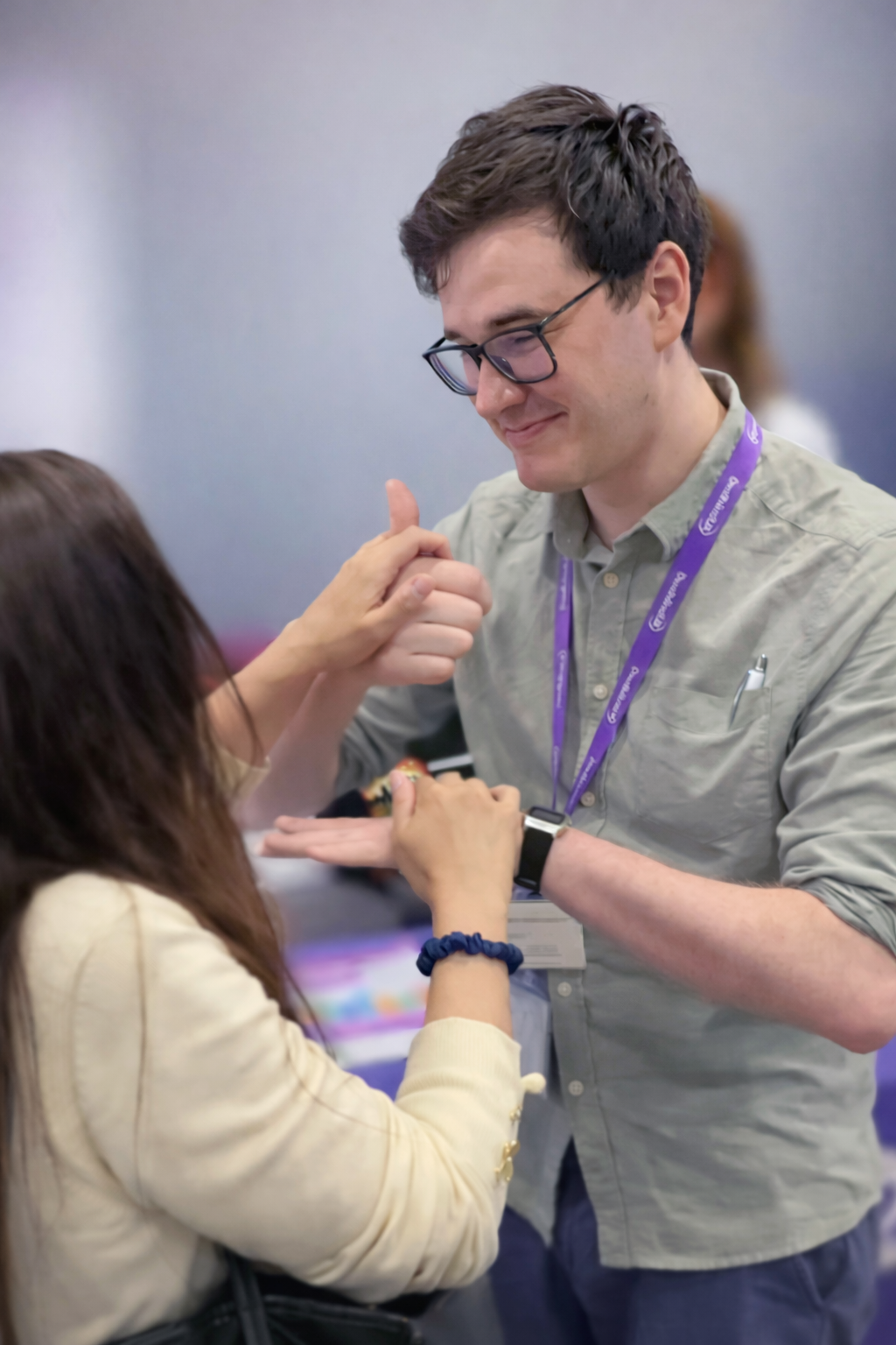 DBUK sensory support officer using hands on BSL with a deafblind girl