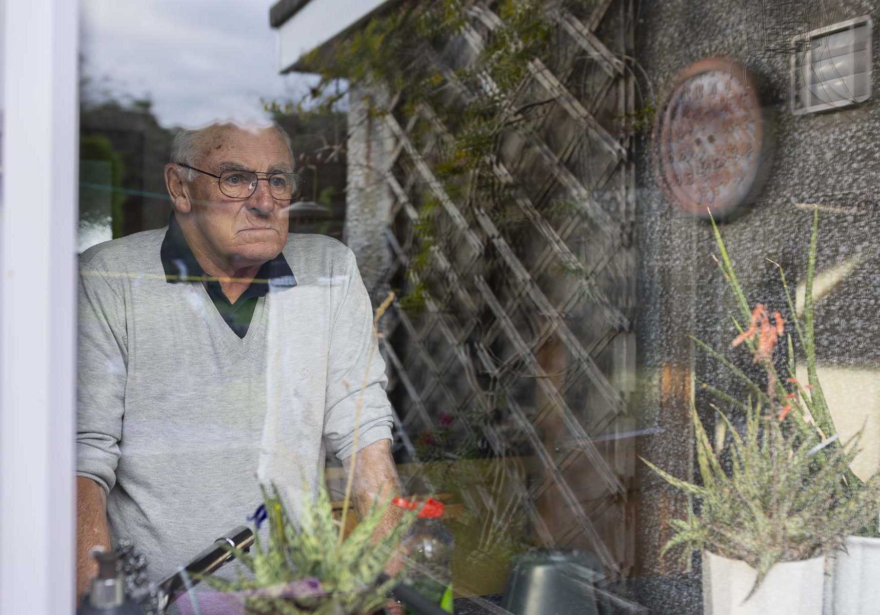 Stuart looks out through his kitchen window